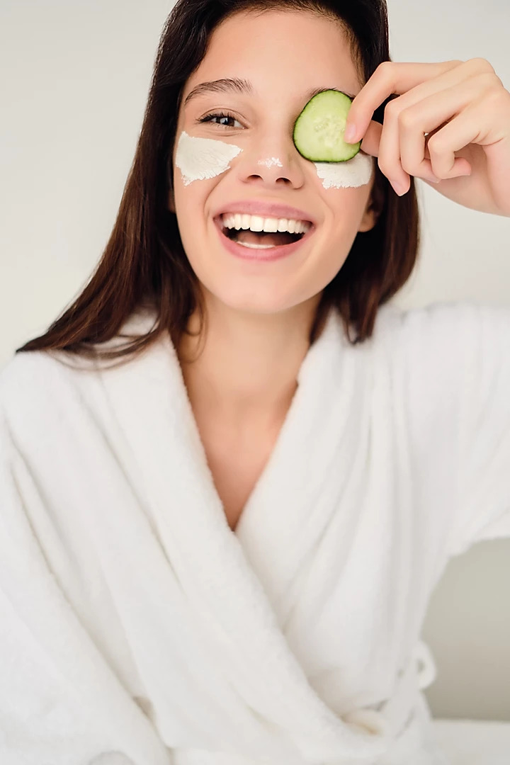woman with cucumber over her eye