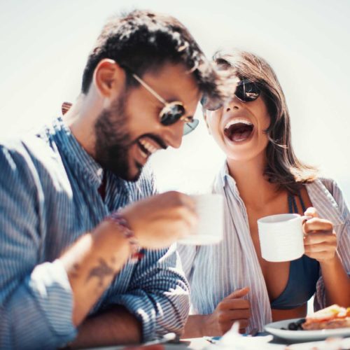 couple laughing over breakfast